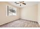 Bedroom with carpet, a ceiling fan, and large window providing natural light at 19226 N Cave Creek Rd # 109, Phoenix, AZ 85024
