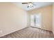 Bedroom featuring a ceiling fan, plush carpet, and double doors leading to the outside at 19226 N Cave Creek Rd # 109, Phoenix, AZ 85024
