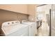Bright laundry room featuring a Whirlpool washer and dryer with direct access to kitchen at 19226 N Cave Creek Rd # 109, Phoenix, AZ 85024