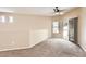 Living room featuring neutral walls, carpet, sliding door to the outside, and transom windows at 19226 N Cave Creek Rd # 109, Phoenix, AZ 85024