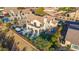 Aerial view of a lovely home with a pool, back patio, turf, and desert landscaping at 19240 N 90Th Pl, Scottsdale, AZ 85255