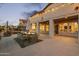 Inviting outdoor back patio with dining area, ceiling fans, and string lights for evening relaxation at 19240 N 90Th Pl, Scottsdale, AZ 85255