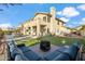 Spacious backyard with patio, turf, and various outdoor activities set against a two story home at 19240 N 90Th Pl, Scottsdale, AZ 85255