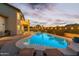Inviting backyard pool with ample seating, patio, and outdoor grill for entertaining at dusk at 19240 N 90Th Pl, Scottsdale, AZ 85255