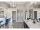 Bright bathroom with patterned floors, double sinks, large mirrors, and a glass shower enclosure at 19240 N 90Th Pl, Scottsdale, AZ 85255