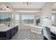 Spacious bathroom boasts patterned floors, double sinks, soaking tub, and a large window at 19240 N 90Th Pl, Scottsdale, AZ 85255