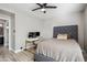 Well-lit bedroom with a gray bed frame, and work area with two monitors on the desk at 19240 N 90Th Pl, Scottsdale, AZ 85255