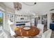 Open-concept dining area with wood table, white chairs, chandelier lighting, and integrated kitchen area at 19240 N 90Th Pl, Scottsdale, AZ 85255