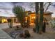 Charming front exterior with desert landscaping, a paver driveway, and arched entryway at 19240 N 90Th Pl, Scottsdale, AZ 85255