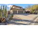 Beautiful two-story home with a three-car garage and inviting desert landscaping at 19240 N 90Th Pl, Scottsdale, AZ 85255