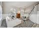 Bright living room with a decorative tiled floor, comfortable seating, and staircase at 19240 N 90Th Pl, Scottsdale, AZ 85255