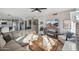 Cozy living room featuring neutral decor, brick fireplace, ceiling fan, and an open floor plan to other rooms at 19240 N 90Th Pl, Scottsdale, AZ 85255