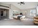 Spacious main bedroom with a ceiling fan, neutral walls, carpet flooring, and a king bed at 19240 N 90Th Pl, Scottsdale, AZ 85255