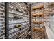 Stunning wine cellar featuring exposed brick and a modern metal and wooden wine rack at 19240 N 90Th Pl, Scottsdale, AZ 85255