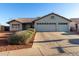 Charming single-story home with a well-manicured front yard and a spacious three-car garage at 20333 N 108Th Ln, Peoria, AZ 85373