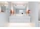 Sleek white bathroom featuring a modern double sink vanity, large mirror and contemporary lighting at 2055 W Windsor Ave, Phoenix, AZ 85009