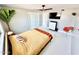 Bright bedroom with a ceiling fan, a television and a modern closet with sliding doors at 2055 W Windsor Ave, Phoenix, AZ 85009
