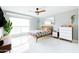 Bright bedroom featuring a unique ceiling fan, large windows, and stylish mid-century modern furnishings at 2055 W Windsor Ave, Phoenix, AZ 85009