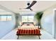 Comfortable bedroom with a modern ceiling fan, bright windows, and minimalist décor at 2055 W Windsor Ave, Phoenix, AZ 85009