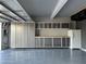 This garage offers custom gray cabinets, an epoxy floor, plenty of work space, and even a refrigerator at 2055 W Windsor Ave, Phoenix, AZ 85009