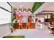 Stylish bar seating area leading to an open living space with eclectic retro-inspired accents at 2055 W Windsor Ave, Phoenix, AZ 85009