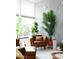 Relaxing living room area with a leather chair and modern floor lamp beside a large window at 2055 W Windsor Ave, Phoenix, AZ 85009
