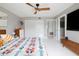 Bright main bedroom featuring modern furniture, large mirror, and a ceiling fan at 2055 W Windsor Ave, Phoenix, AZ 85009