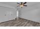 Bright bedroom featuring wood-look tile flooring and a closet at 2447 E La Jolla Dr, Tempe, AZ 85282