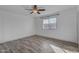 Bright bedroom features wood-look tile flooring and a ceiling fan at 2447 E La Jolla Dr, Tempe, AZ 85282