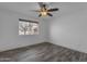 Bedroom featuring wood-look tile flooring, a ceiling fan, and white walls at 2447 E La Jolla Dr, Tempe, AZ 85282