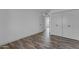 Bright bedroom features wood-look tile flooring, a closet, and white walls at 2447 E La Jolla Dr, Tempe, AZ 85282