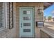 Stylish turquoise front door with modern design, decorative sidelight, and brick facade at 2447 E La Jolla Dr, Tempe, AZ 85282