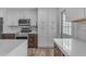 Well-equipped kitchen with stainless steel appliances, quartz countertops, and ample storage space at 2447 E La Jolla Dr, Tempe, AZ 85282