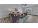 Bright living room features tile floors, cozy seating, and a large window with natural light at 2447 E La Jolla Dr, Tempe, AZ 85282