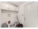 Utility Room with overhead cabinets, white paneling, and patterned floors at 245 S 56Th St # 262, Mesa, AZ 85206