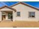Backyard with a covered patio area, desert landscaping, and a sliding glass door at 25610 N 144Th Ln, Surprise, AZ 85387