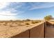 Expansive desert landscape and sunny blue skies from the backyard of this home at 25610 N 144Th Ln, Surprise, AZ 85387