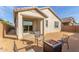 This backyard features desert landscaping and a covered patio area at 25610 N 144Th Ln, Surprise, AZ 85387