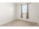 This bedroom features neutral carpeting, a window with curtains, and neutral walls at 25610 N 144Th Ln, Surprise, AZ 85387