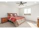 Bright bedroom with carpet flooring, ceiling fan, and natural light from a large window at 25610 N 144Th Ln, Surprise, AZ 85387