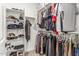 Walk-in closet with organized shelving and racks for efficient storage of clothing and shoes at 25610 N 144Th Ln, Surprise, AZ 85387