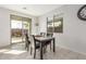 Cozy dining area with a modern table and chairs, plus a sliding glass door to the backyard at 25610 N 144Th Ln, Surprise, AZ 85387