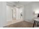 Hallway that leads to a living room and office space with carpet and tile flooring at 25610 N 144Th Ln, Surprise, AZ 85387