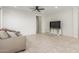 Open-concept living room with tile floors, ceiling fan, neutral tones and a comfortable sofa at 25610 N 144Th Ln, Surprise, AZ 85387