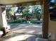 Covered patio offers views of the pool, lush lawn, and mature trees at 265 E Liberty Ln, Gilbert, AZ 85296