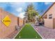Backyard with putting green, outdoor kitchen, and block wall at 265 E Liberty Ln, Gilbert, AZ 85296