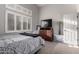 Bright bedroom featuring shutters, carpet flooring, and neutral-colored walls at 265 E Liberty Ln, Gilbert, AZ 85296