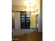 Welcoming foyer showcasing a decorative light fixture, tile flooring, and unique door at 265 E Liberty Ln, Gilbert, AZ 85296