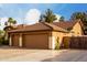Spacious three-car garage offers ample parking and storage space at the end of a driveway at 265 E Liberty Ln, Gilbert, AZ 85296