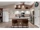 Well-equipped kitchen with stainless steel appliances, an island with barstools, and ample cabinets at 265 E Liberty Ln, Gilbert, AZ 85296